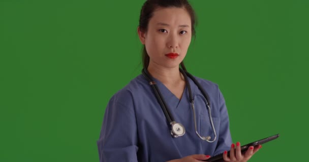 Serious Medical Assistant Posing Tablet Greenscreen Close Young Professional Nurse — Stock Video