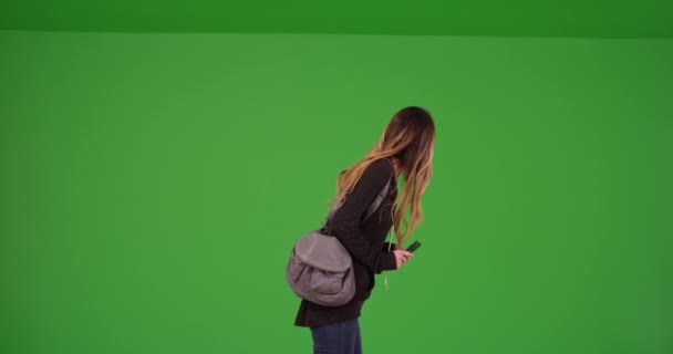 緑の画面上の携帯電話で若い千年紀の女の子のメッセージ 緑の画面でキーまたは構成されます — ストック動画