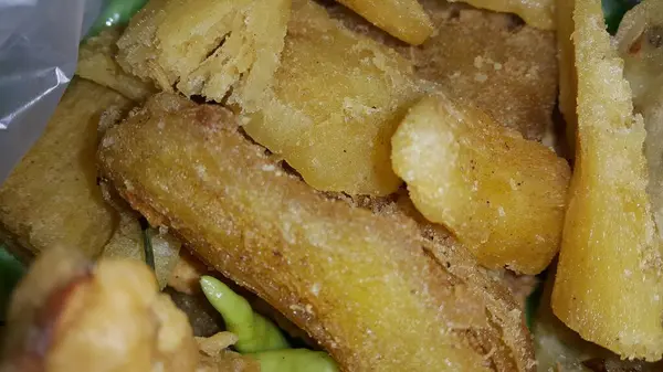 stock image Close up shot of very delicious fried cassava texture. Fried cassava, also known as Singkong Goreng in Indonesian, is a popular dish. One of traditional snack to break the Fast at Ramadan.