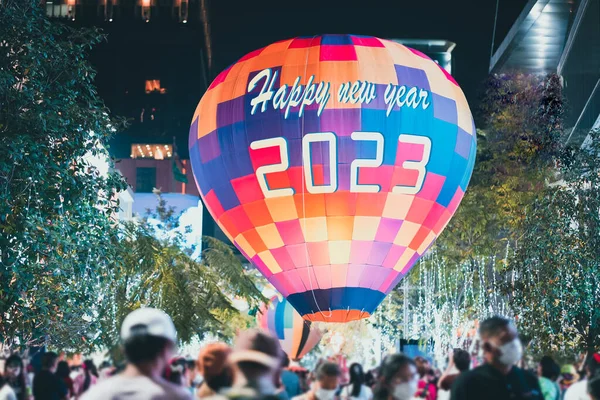 Organizing the New Year 2023 festival celebration. Write the word Happy New Year 2023 on the balloon and celebrating new year eve.