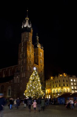 Mariack kilisesinin önündeki meydanda Noel ağacı. Polonya, Krakow 'da Noel ışıklarında gece şehri