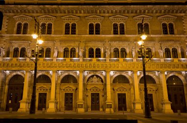 Corwin Üniversitesi. Gece fenerlerin ışığında antik üniversitenin ön cephesi. Budapeşte, Macaristan