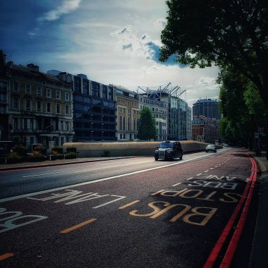 typical english taxi with background of beautiful modern buildings