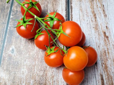 ahşap bir masa üzerinde taze kırmızı domates.