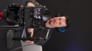 Camera screen recording young mans video tutorial for vlog, doing video product reviews for social media. Content creator concept. Focus on foreground, Vertical, 4k video.