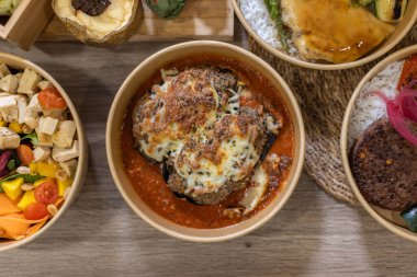 Hearty serving of baked eggplant parmesan covered in melted cheese and rich tomato sauce. Golden, crispy, and comforting, this dish embodies homemade Italian flavors with modern takeaway presentation