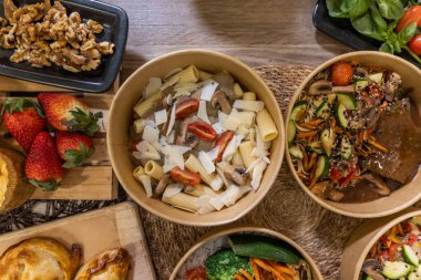 Kremalı mantar soslu rigatoni makarna, vişneli domates ve kağıt kasede rendelenmiş peynir. Restoran konsepti, çevre dostu ambalaj.