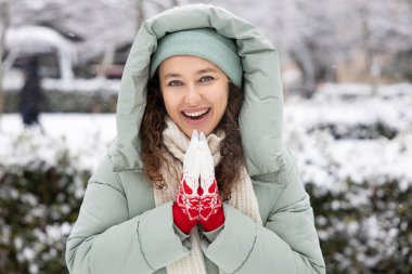 Young woman in warm clothes on a cold snowy day