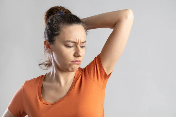 Young Woman Who Sniffs Armpits Her Face Negative Isolated Gray — Stockfoto