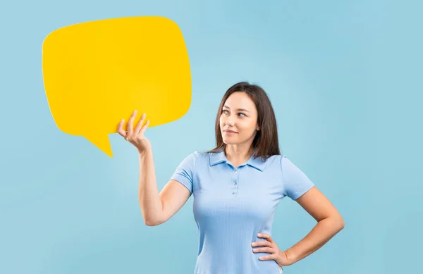 Young Woman Holding Speech Bubble Isolated Blue Wall — Photo