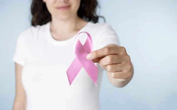 Breast cancer awareness ribbon. Woman holding pink ribbo
