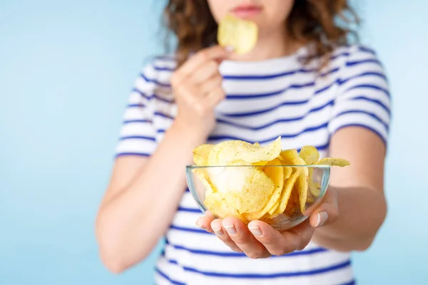 Woman on diet can\'t resist craving to eat potato chips. Food addiction, diet breakdown, compulsive overeating concept