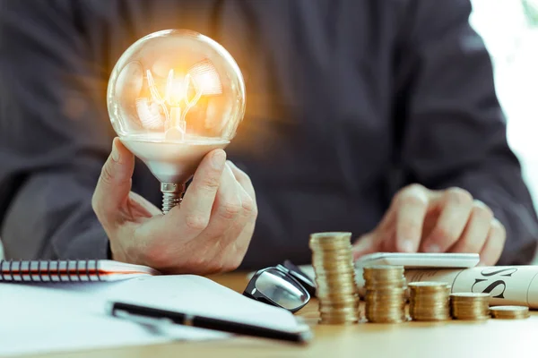 Business Man Hand Hålla Glödlampa Med Hjälp Miniräknare Sparande Energi — Stockfoto