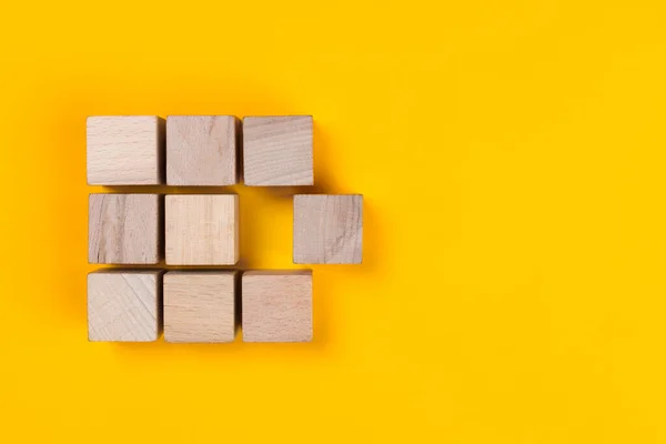 stock image Wooden cube block group and another cube block detached from the group