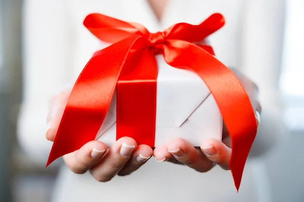 Woman Showing White Small Gift Box Red Ribbo — Stock Photo, Image