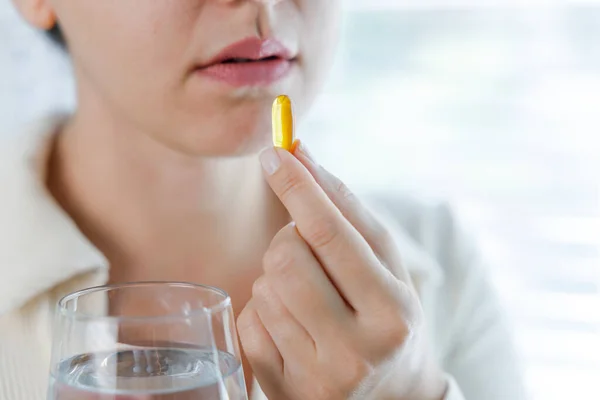 Young Woman Taking Omega Capsule — Stock Photo, Image