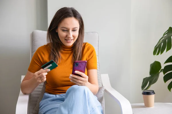 Young Woman Entering Credit Card Information Using Smart Phone Online — Stock Photo, Image