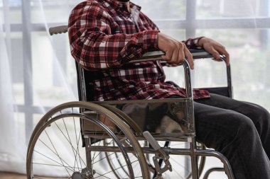 Tekerlekli sandalyedeki adama yakın çekim. Sağlık konsept rehabilitasyon merkezinde tekerlekli sandalyedeki yaralı adam..