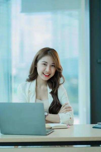 Asian woman working in accounting with laptopThat calculates household finances with a calculator on the expense planning desk. debt and loan business and finance concept tax vertical picture