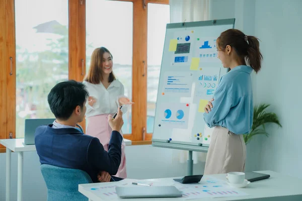 Young happy Asian businessman working together to start a business in creative team brainstorming meeting Successful business partner team work concept