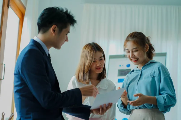 Young happy Asian businessman working together to start a business in creative team brainstorming meeting Successful business partner team work concept