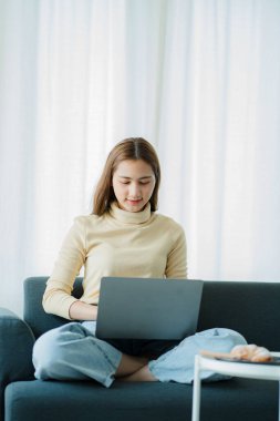 Sosyal medya ve iş iletişimi ve teknoloji kavramı için dizüstü bilgisayar kullanan Asyalı kadın