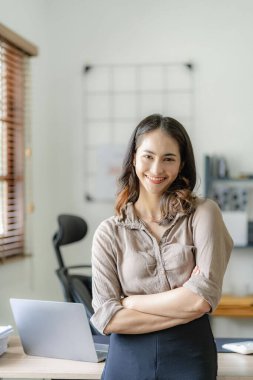 Muhasebe ya da Tasarruf Şirketi ile teknik fiyat grafiklerini ve göstergeleri analiz etmeye çalışan Asyalı kadın muhasebeci..