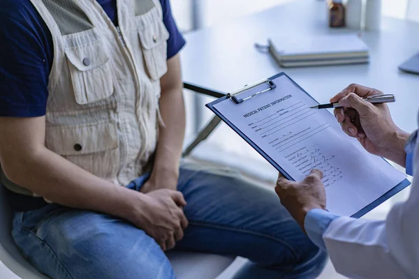 Female doctor and male testicular cancer patient discuss test results. Concerned about prostate cancer is seeking advice from a counselor who specializes in prostate cancer.
