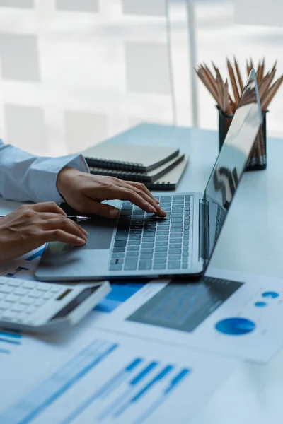 stock image Businessman holding a pen pointing to a graph chart Company financial documents prepared by finance department for meetings with business partners. Vertical image. Finance concept.