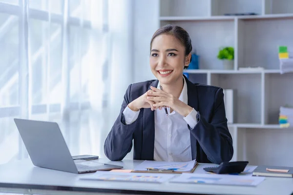 stock image Economic concept Asian female accountant or banker calculating financial accounts. Young Asian businesswoman at work. Documents, taxes, analysis reports, savings and finances.