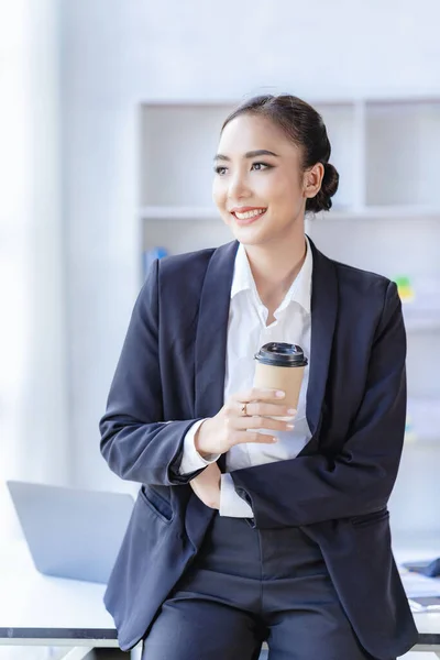 stock image Economic concept Asian female accountant or banker calculating financial accounts. Young Asian businesswoman at work. Documents, taxes, analysis reports, savings and finances.