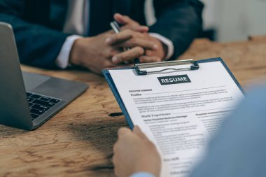 İş Bulma Kurumu Müdürü, iş başvurusu formunun özgeçmişini doldurmak için iş başvurusu yapan biriyle görüşüyor.