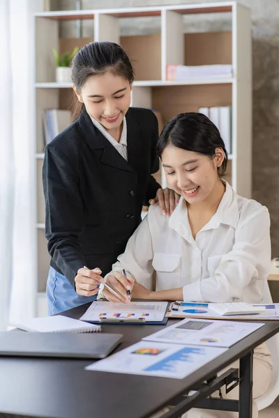 stock image Two young asian accountants working on laptop computer and finance at workplace. Freelance business. Online marketing. ecommerce marketing ideas