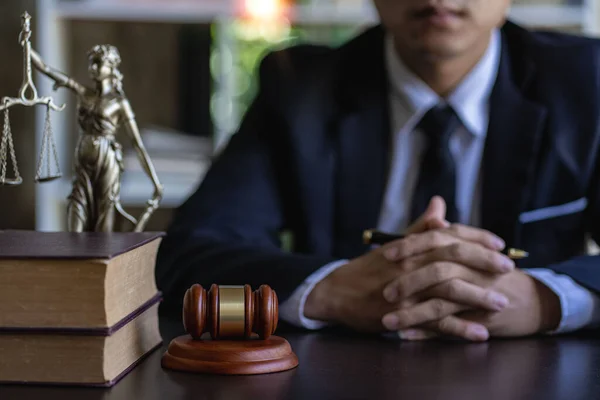 stock image Asian lawyer working on financial information, checking financial accounts and helping clients working on desktop with legal case documents at workplace for consultant. Law, advice and justice
