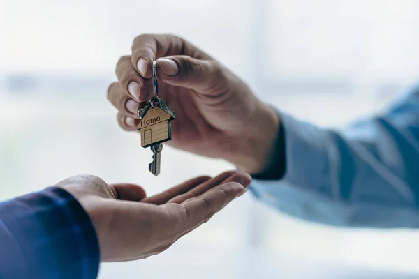 Real estate agent holding house keys for his client after contract signing Move house or rent Home buying ideas and home insurance for real estate