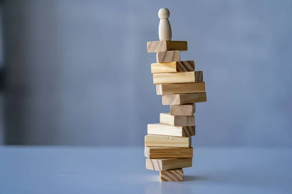 planning, risk and project management strategies in business Businessman and engineer gambling placing wooden blocks on tower Business and construction success concept