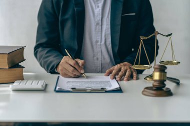 Lawyer office male working with hammer and scales with document, contract, legal adviser concept.