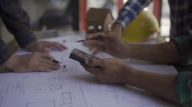 civil engineer team Together with the architect and foreman, view the blue print and plan the construction of the building. In the office at the construction site 4k
