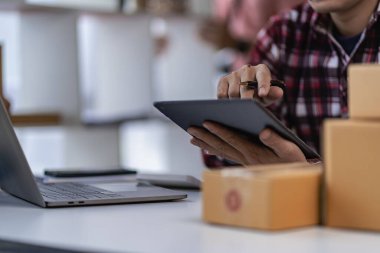 Male businessman starting a successful small business SME freelance work from home with laptop online shopping with online parcel delivery. SME and package delivery concept.