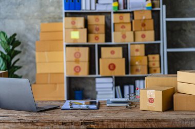 Businesswoman starting a small business SME success Freelance woman working from home with laptop online shopping with online parcel delivery. SME concept and package delivery.