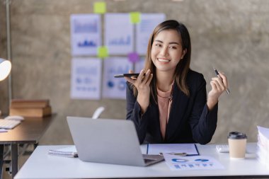 Asian businesswoman working with calculator to analyze business data and financial concept Female accountant working with computer and for business and financial expenses charming asian girl