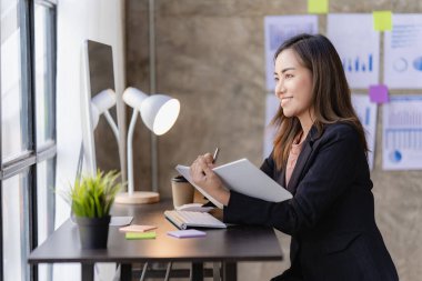 Asian businesswoman working with calculator to analyze business data and financial concept Female accountant working with computer and for business and financial expenses charming asian girl