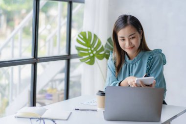 Asian businesswoman working with calculator to analyze business data and financial concept Female accountant working with computer and for business and financial expenses charming asian girl