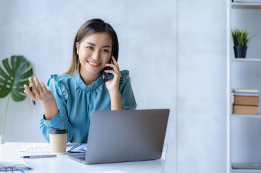 Asian businesswoman working with calculator to analyze business data and financial concept Female accountant working with computer and for business and financial expenses charming asian girl