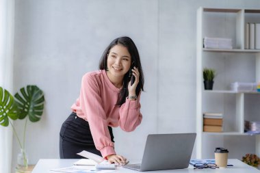 Asian businesswoman working with calculator to analyze business data and financial concept Female accountant working with computer and for business and financial expenses charming asian girl