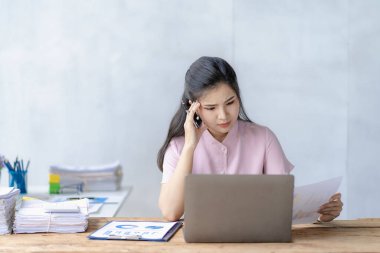 Young businesswoman and beautiful asian woman tired from office work Woman with head down in office due to stress from working too much with paperwork