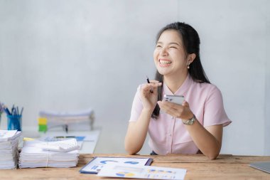 Asian businesswoman working with calculator to analyze business data and financial concept Female accountant working with computer and for business and financial expenses charming asian girl