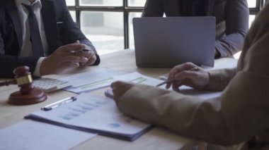 Sales department has a monthly briefing meeting to present to the manager to verify the accuracy of the documents prepared before submitting them to the manager with a hammer next to the finance approval concept.