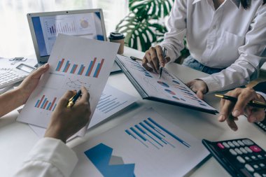 Intelligence analysis concept, group of business people brainstorm discussing current finance and economy on company investment laptop at meeting