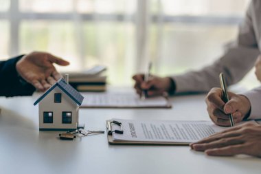 Real estate agents offer contracts to buy or rent housing. with house model, small building, property insurance, mortgage, real estate